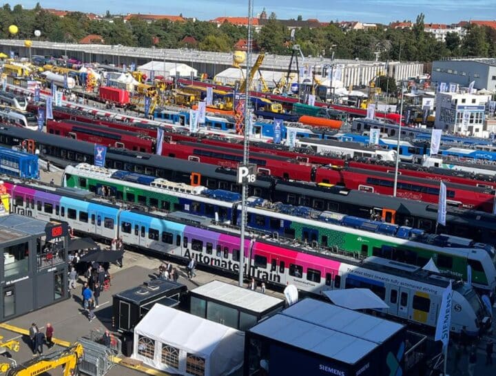 A wide aerial view of the InnoTrans exhibition in Berlin, showcasing a diverse array of next-generation trains and transport technology from global manufacturers.