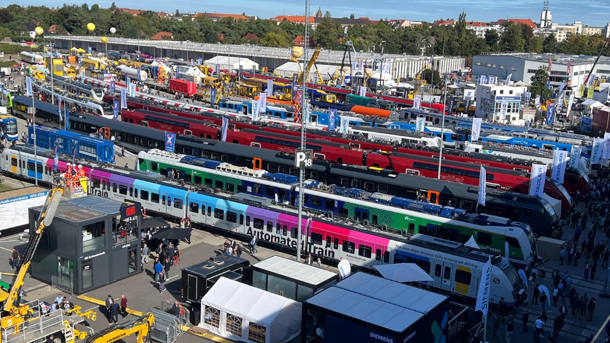 A wide aerial view of the InnoTrans exhibition in Berlin, showcasing a diverse array of next-generation trains and transport technology from global manufacturers.